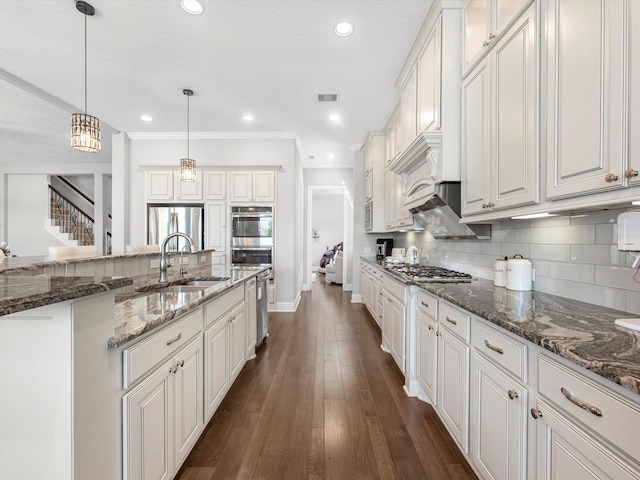 16819 Himley Dr, Cypress, TX 77433 - kitchen featuring a sink, appliances with stainless steel finishes, backsplash, baseboards, and hanging light fixtures