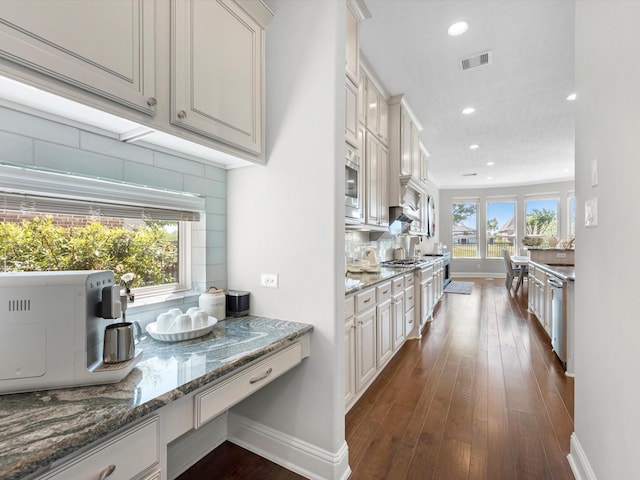16819 Himley Dr, Cypress, TX 77433 - kitchen with dark wood-type flooring, decorative backsplash, baseboards, and recessed lighting