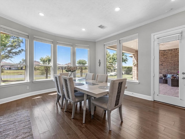16819 Himley Dr, Cypress, TX 77433 - dining room featuring ornamental molding, dark wood finished floors, baseboards, and recessed lighting