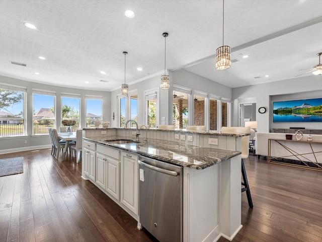 16819 Himley Dr, Cypress, TX 77433 - kitchen with dishwasher, a sink, open floor plan, a center island with sink, and dark wood-style floors