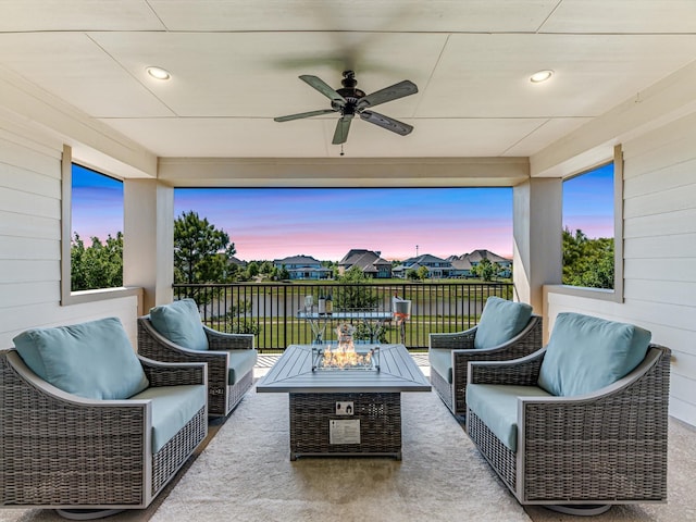 16819 Himley Dr, Cypress, TX 77433 - patio terrace at dusk with a ceiling fan, an outdoor living space with a fire pit, and a patio