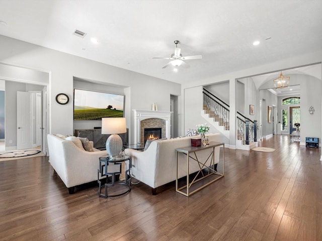 16819 Himley Dr, Cypress, TX 77433 - living room with stairway, dark wood finished floors, a glass covered fireplace, a ceiling fan, and recessed lighting