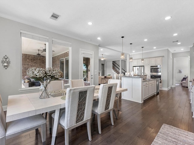 16819 Himley Dr, Cypress, TX 77433 - dining area featuring ceiling fan, recessed lighting, dark wood-type flooring, stairs, and crown molding