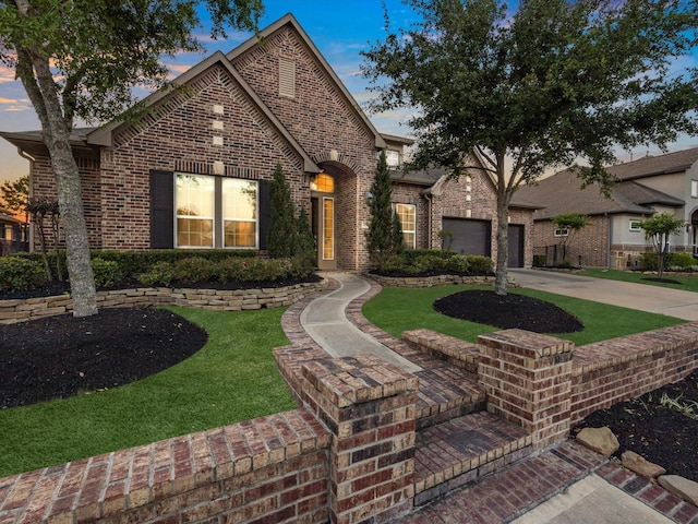 16819 Himley Dr, Cypress, TX 77433 - view of front of house featuring brick siding, driveway, an attached garage, and a front yard