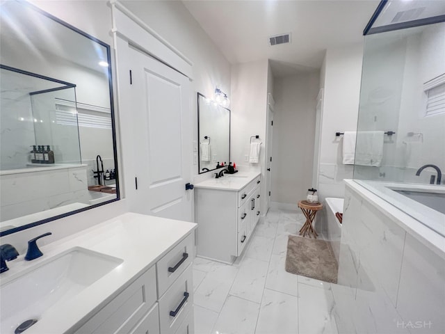 5402 Wheatley St Unit D, Houston, TX 77091 - bathroom featuring two vanities, marble finish flooring, a garden tub, a marble finish shower, and baseboards