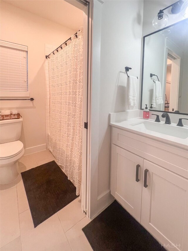 5402 Wheatley St Unit D, Houston, TX 77091 - full bathroom with tile patterned flooring, toilet, vanity, baseboards, and a shower with shower curtain