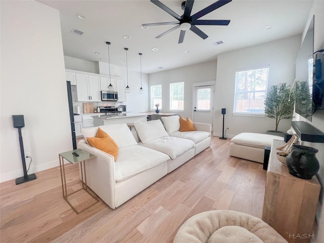 5402 Wheatley St Unit D, Houston, TX 77091 - living room with ceiling fan, light wood-style flooring, baseboards, and recessed lighting