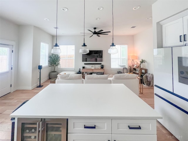 5402 Wheatley St Unit D, Houston, TX 77091 - kitchen featuring beverage cooler, plenty of natural light, a center island, white cabinetry, and recessed lighting