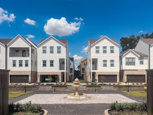 5402 Wheatley St Unit D, Houston, TX 77091 - townhome / multi-family property with stucco siding, a garage, and decorative driveway