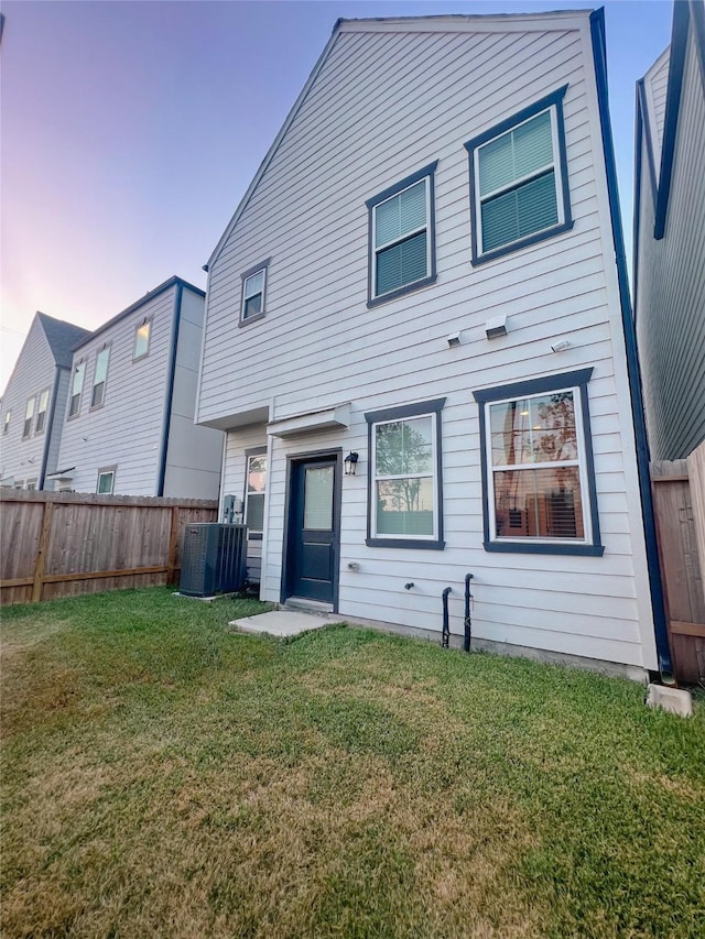 5402 Wheatley St Unit D, Houston, TX 77091 - back of house at dusk featuring central AC