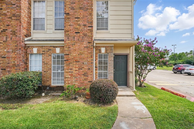 2626 Holly Hall St Unit 1102, Houston, TX 77054 - entrance to property with brick siding and a lawn