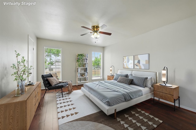 2626 Holly Hall St Unit 1102, Houston, TX 77054 - bedroom with wood finished floors, baseboards, and a ceiling fan