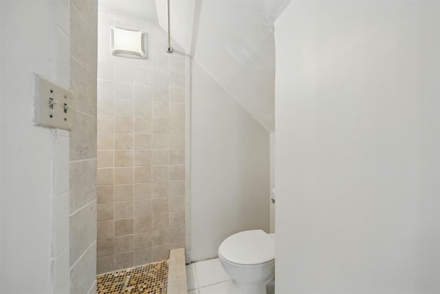 2626 Holly Hall St Unit 1102, Houston, TX 77054 - bathroom featuring a tile shower, toilet, and tile patterned floors
