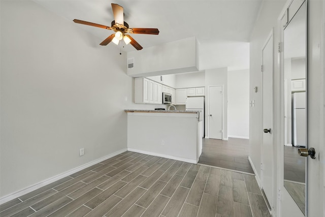 2626 Holly Hall St Unit 1102, Houston, TX 77054 - unfurnished living room featuring baseboards, ceiling fan, and dark wood-type flooring