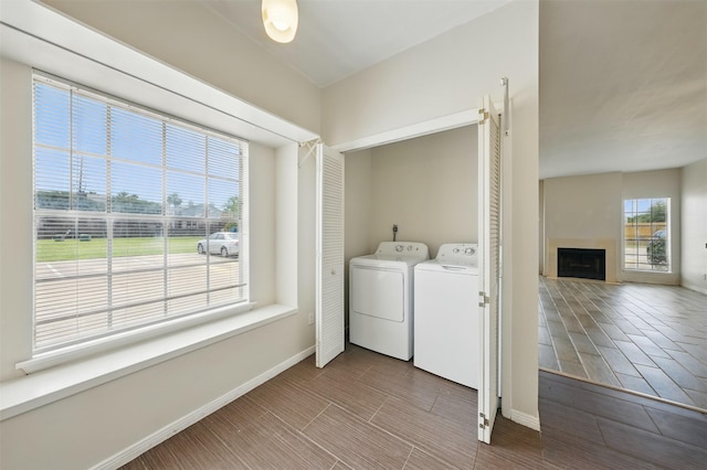 2626 Holly Hall St Unit 1102, Houston, TX 77054 - washroom with washer and dryer, a fireplace, and baseboards