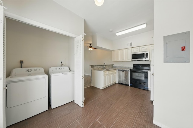 2626 Holly Hall St Unit 1102, Houston, TX 77054 - washroom with electric panel, washer and dryer, a ceiling fan, and dark wood-type flooring