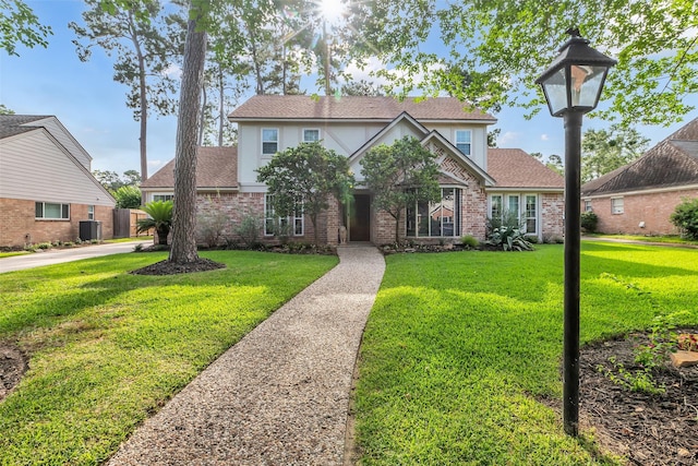 16310 Sir William Dr, Spring, TX 77379 - view of front facade with brick siding, a front lawn, central AC, and stucco siding