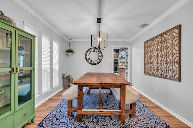 16310 Sir William Dr, Spring, TX 77379 - dining space featuring light wood finished floors, crown molding, and baseboards