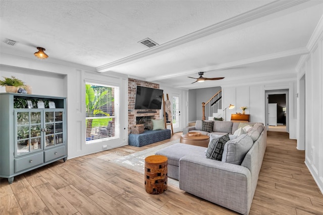 16310 Sir William Dr, Spring, TX 77379 - living area featuring stairway, a textured ceiling, wood finished floors, beamed ceiling, and a ceiling fan