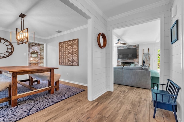 16310 Sir William Dr, Spring, TX 77379 - dining area featuring wood finished floors, ornamental molding, a large fireplace, a chandelier, and baseboards