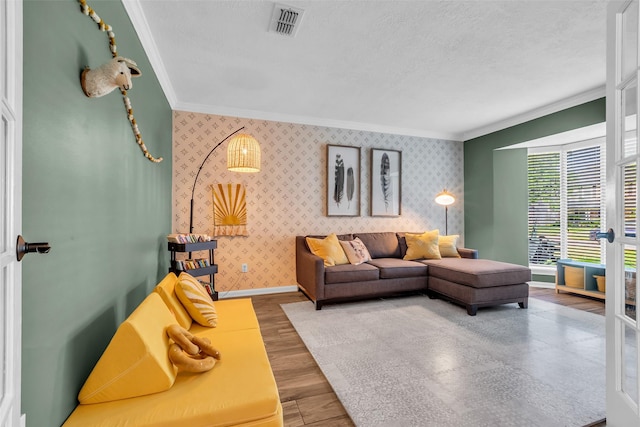 16310 Sir William Dr, Spring, TX 77379 - living room featuring wallpapered walls, crown molding, baseboards, wood finished floors, and a textured ceiling