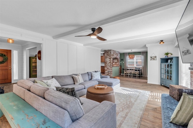 16310 Sir William Dr, Spring, TX 77379 - living room with ornamental molding, beam ceiling, a ceiling fan, and light wood-style flooring
