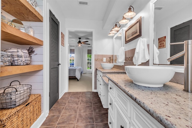 16310 Sir William Dr, Spring, TX 77379 - bathroom with double vanity, ensuite bath, a ceiling fan, and tile patterned floors