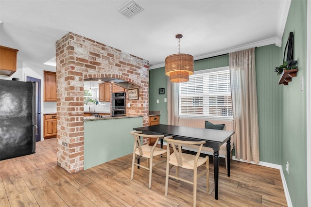 16310 Sir William Dr, Spring, TX 77379 - dining area featuring light wood-style floors, crown molding, and baseboards
