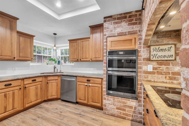 16310 Sir William Dr, Spring, TX 77379 - kitchen with stainless steel appliances, a sink, light wood-style floors, a raised ceiling, and decorative light fixtures