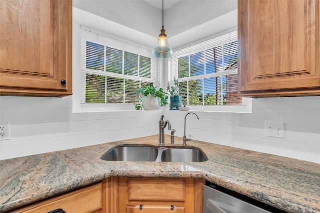 16310 Sir William Dr, Spring, TX 77379 - kitchen featuring a sink, stainless steel dishwasher, light stone counters, and brown cabinets