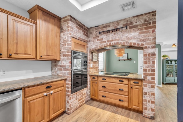 16310 Sir William Dr, Spring, TX 77379 - kitchen with dishwasher, multiple ovens, light wood-style flooring, black electric cooktop, and arched walkways