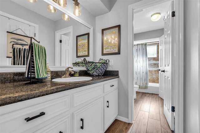 16310 Sir William Dr, Spring, TX 77379 - bathroom featuring vanity, toilet, shower / bath combo with shower curtain, baseboards, and wood finished floors