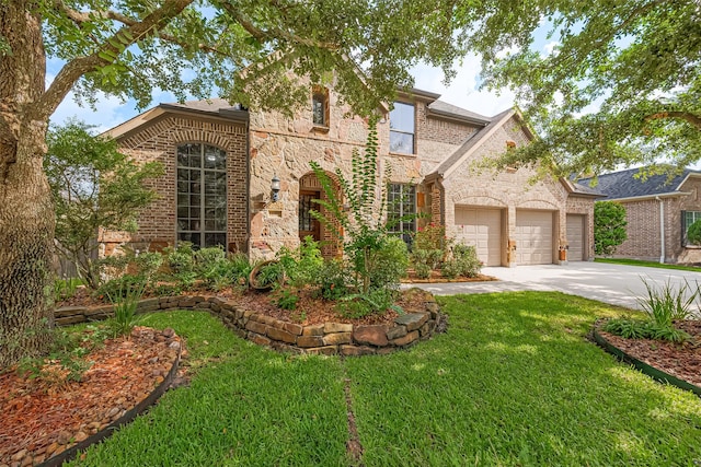 11907 Wind Cove Place Ct, Humble, TX 77346 - view of front of house with brick siding, a garage, concrete driveway, and a front yard