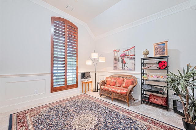 11907 Wind Cove Place Ct, Humble, TX 77346 - sitting room featuring crown molding, lofted ceiling, a wainscoted wall, tile patterned floors, and a decorative wall