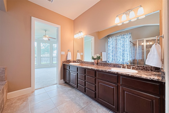 11907 Wind Cove Place Ct, Humble, TX 77346 - full bathroom featuring double vanity, a shower stall, ceiling fan, tile patterned flooring, and baseboards