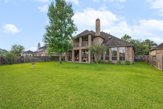 11907 Wind Cove Place Ct, Humble, TX 77346 - back of property with brick siding, a balcony, a chimney, and a patio