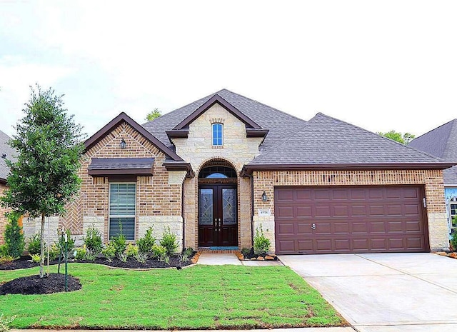 4914 Ava Meadows Ln, Sugar Land, TX 77479 - french country style house with brick siding, a garage, a front lawn, and driveway