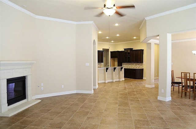 4914 Ava Meadows Ln, Sugar Land, TX 77479 - unfurnished living room with a ceiling fan, light tile patterned floors, recessed lighting, crown molding, and a glass covered fireplace