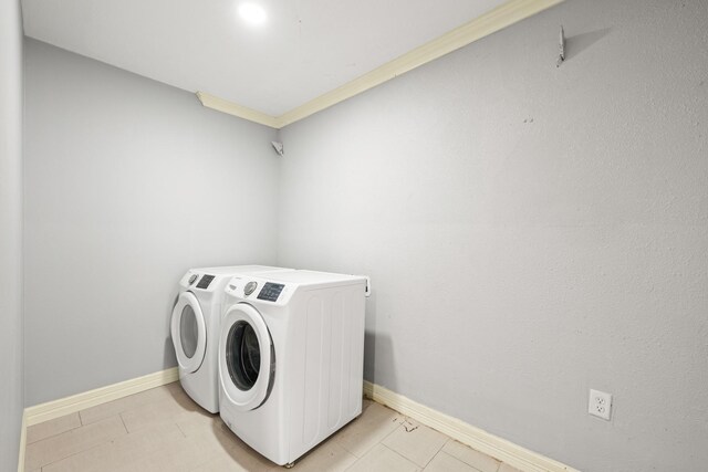 2701 Oaks Dr, Pasadena, TX 77502 - washroom featuring washing machine and dryer, baseboards, and ornamental molding