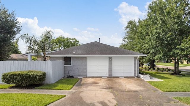 2701 Oaks Dr, Pasadena, TX 77502 - view of property exterior featuring roof with shingles, driveway, an attached garage, and brick siding