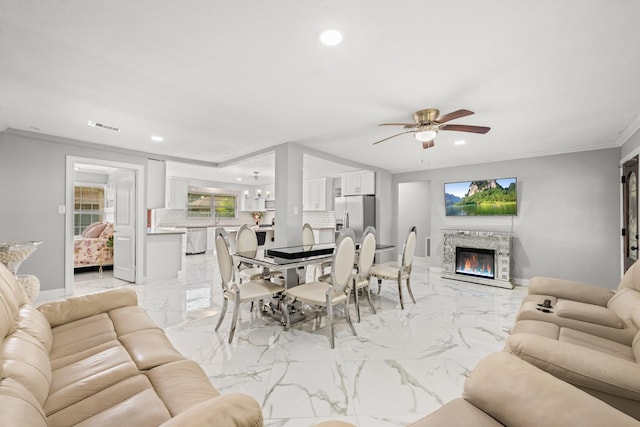 2701 Oaks Dr, Pasadena, TX 77502 - living area featuring light marble finish floors, recessed lighting, ceiling fan, a stone fireplace, and baseboards