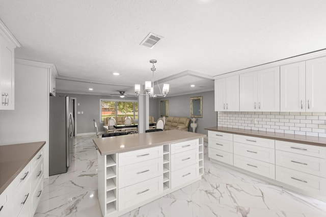 2701 Oaks Dr, Pasadena, TX 77502 - kitchen with freestanding refrigerator, open shelves, light marble finish flooring, open floor plan, and recessed lighting