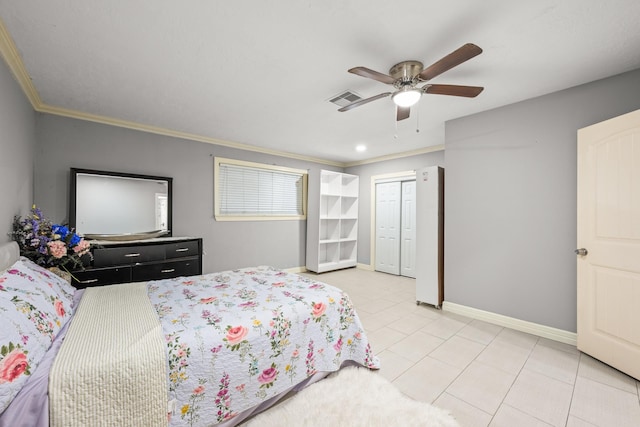 2701 Oaks Dr, Pasadena, TX 77502 - bedroom with ornamental molding, light tile patterned floors, baseboards, a ceiling fan, and a closet