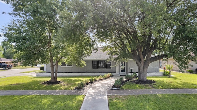 2701 Oaks Dr, Pasadena, TX 77502 - obstructed view of property with brick siding and a front lawn