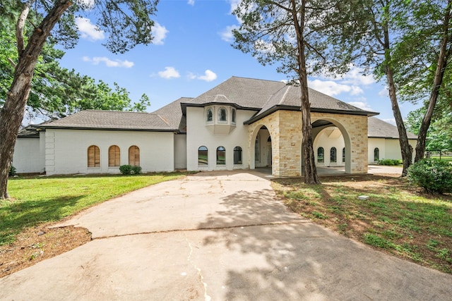 21310 Rosehill Church Rd, Tomball, TX 77377 - french country home featuring a front yard, driveway, stucco siding, and a shingled roof