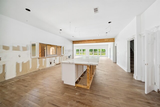 21310 Rosehill Church Rd, Tomball, TX 77377 - kitchen with hardwood / wood-style flooring, a center island, light stone counters, and open floor plan