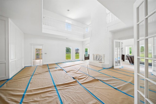 21310 Rosehill Church Rd, Tomball, TX 77377 - unfurnished living room with a towering ceiling and healthy amount of natural light