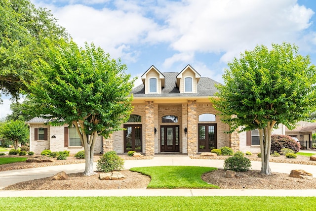 51 Northwood Ct, Lake Jackson, TX 77566 - view of front of property featuring french doors, roof with shingles, a front lawn, and curved driveway