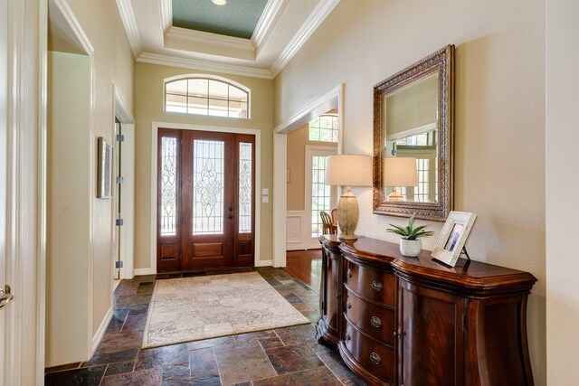 51 Northwood Ct, Lake Jackson, TX 77566 - foyer entrance with crown molding, stone tile floors, baseboards, and a raised ceiling