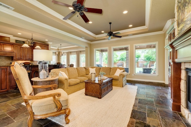 51 Northwood Ct, Lake Jackson, TX 77566 - living area with stone tile flooring, a raised ceiling, a ceiling fan, ornamental molding, and recessed lighting